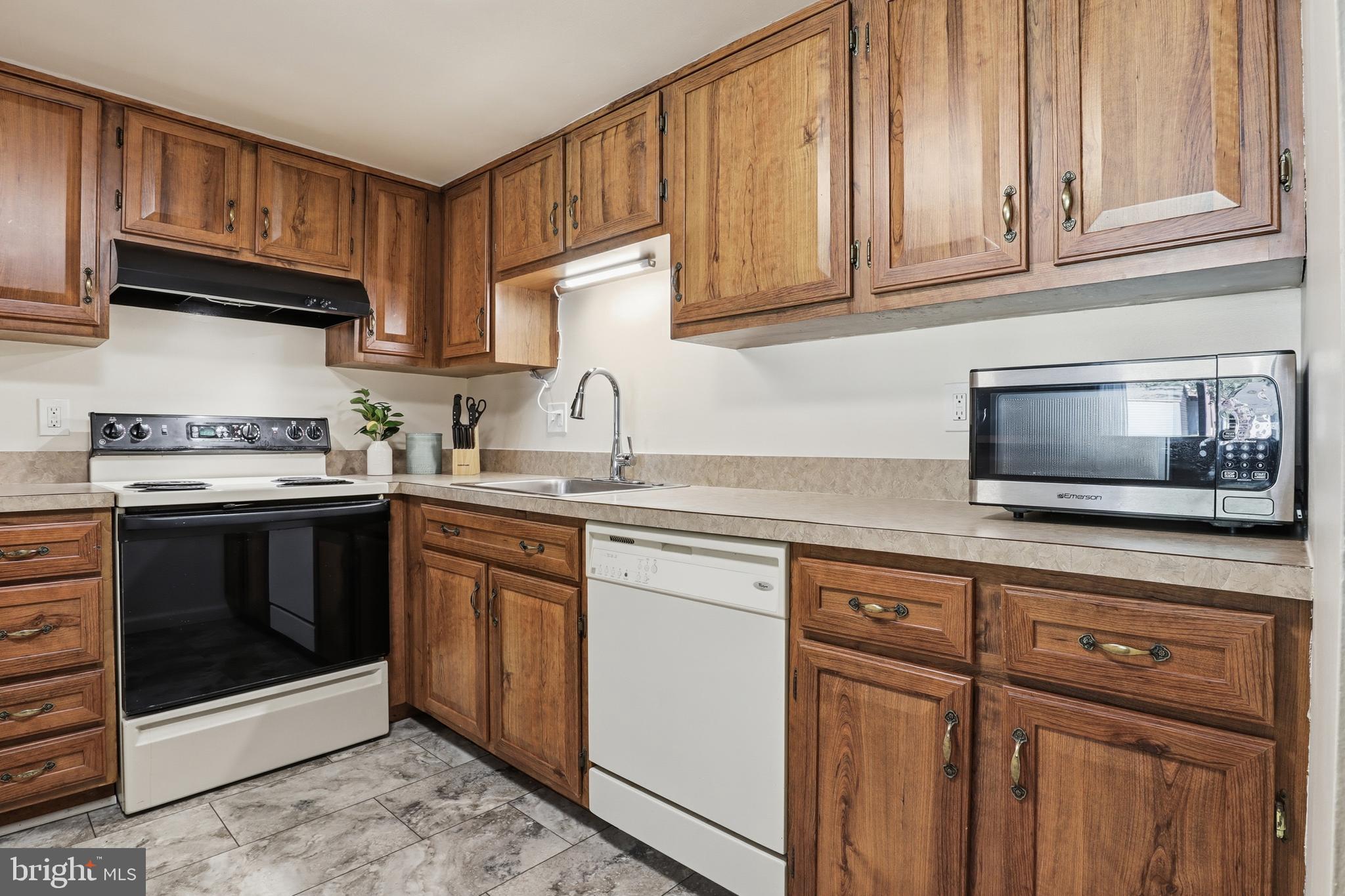 1204 Georgetown Road Middletown, PA 17057 - Photo 11 of 37 a kitchen with granite countertop cabinets stainless steel appliances and wooden floor