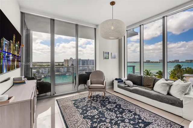 a living room with furniture and a floor to ceiling window