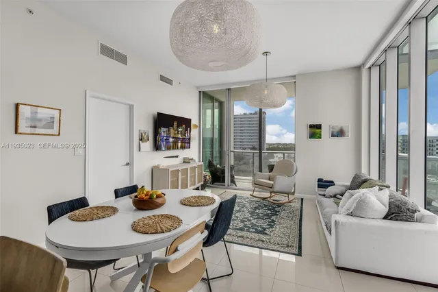a living room with furniture a rug and a large window