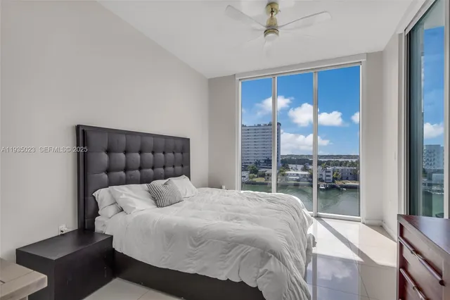 a bedroom with a bed and a large mirror