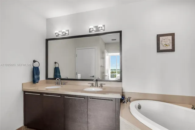 a bathroom with a granite countertop sink a toilet and mirror