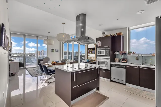 a kitchen with stainless steel appliances granite countertop a sink and cabinets