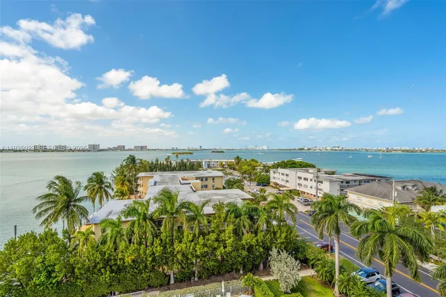 a view of a balcony with wooden floor & fence
