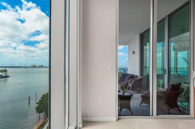 a living room with furniture and a floor to ceiling window