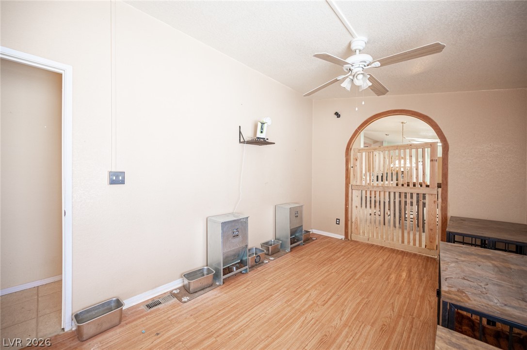 3200 Maple Road Pahrump, NV 89048 - Photo 22 of 53 Warm wood-look flooring extends through this versatile room, featuring a charming arched entryway.