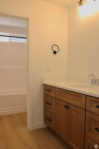 2613 Scarlet Road, Unit 258 Eagle Mountain, UT 84005 - Photo 22 of 32 Bathroom featuring a wood-finish vanity with a light-colored countertop and undermount sink