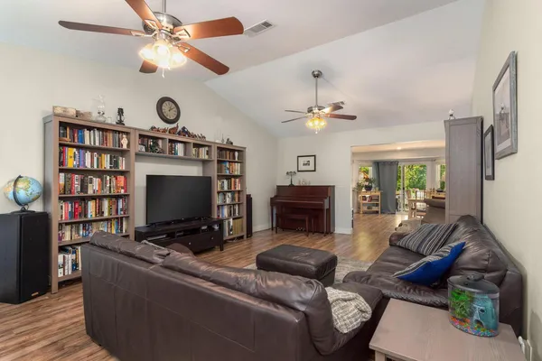 a living room with furniture a flat screen tv and a fireplace