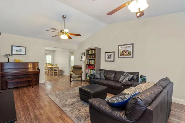 a living room with furniture a couch and a chandelier