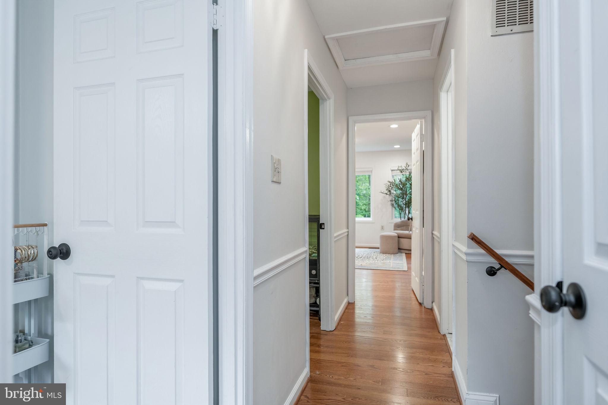 7603 Modisto Lane Springfield, VA 22153 - Photo 34 of 57 a view of a hallway with wooden floor and staircase