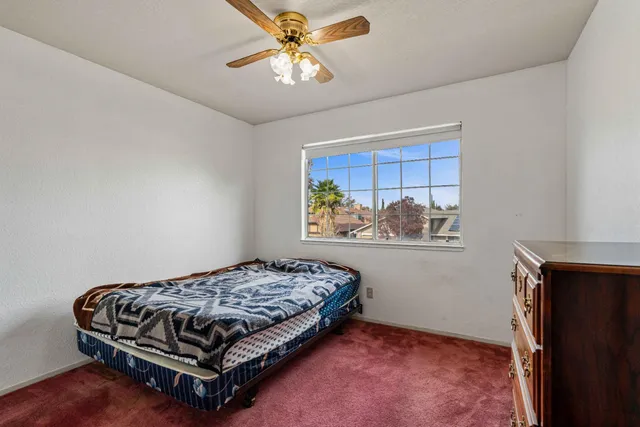 a bedroom with a bed and window