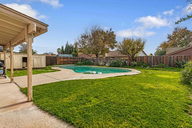 a view of a patio with a table and chairs