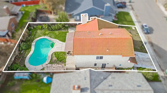 an aerial view of a house with a garden and swimming pool