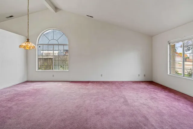 an empty room with windows and pillars in it