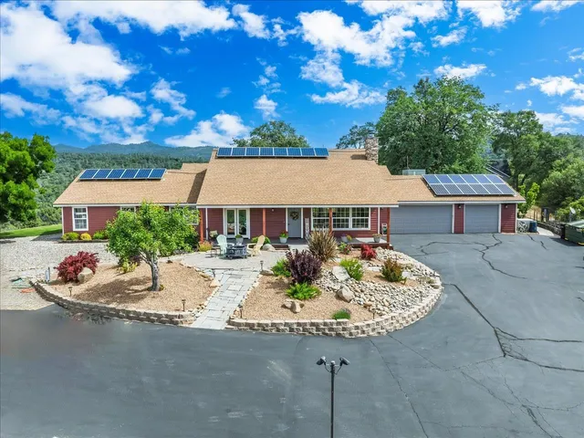 a aerial view of a house with a garden and patio