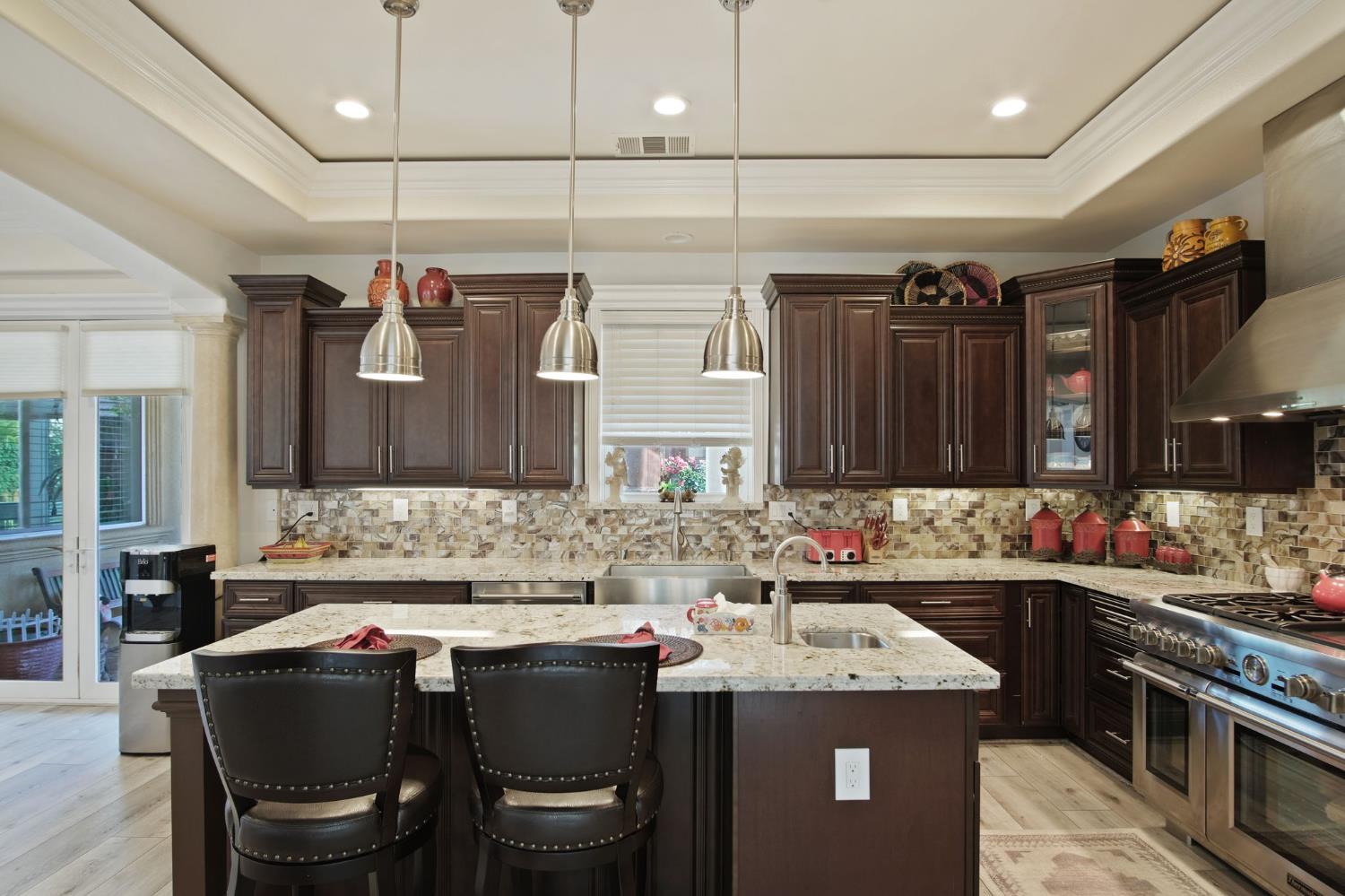 3205 Hillglen Avenue Modesto, CA 95355 - Photo 15 of 45 a kitchen with a sink and chairs