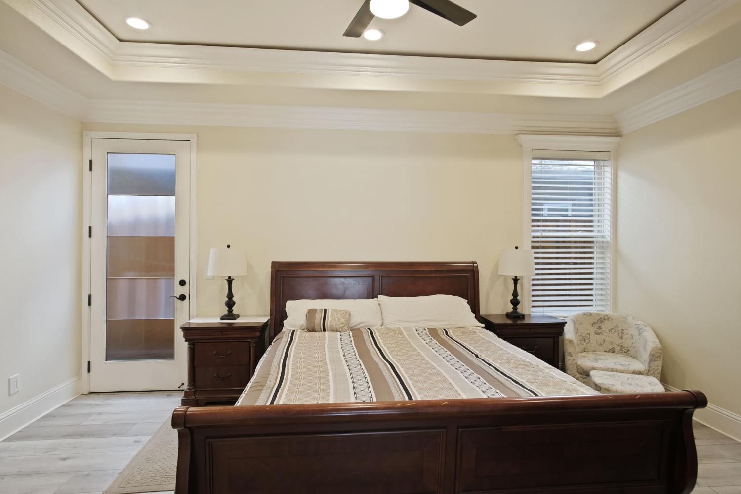 3205 Hillglen Avenue Modesto, CA 95355 - Photo 19 of 45 a bed sitting in a bedroom next to a window and a chandelier