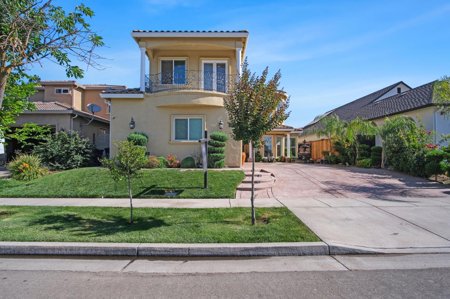 3205 Hillglen Avenue Modesto, CA 95355 - Photo 2 of 45 a front view of a house with a yard and trees