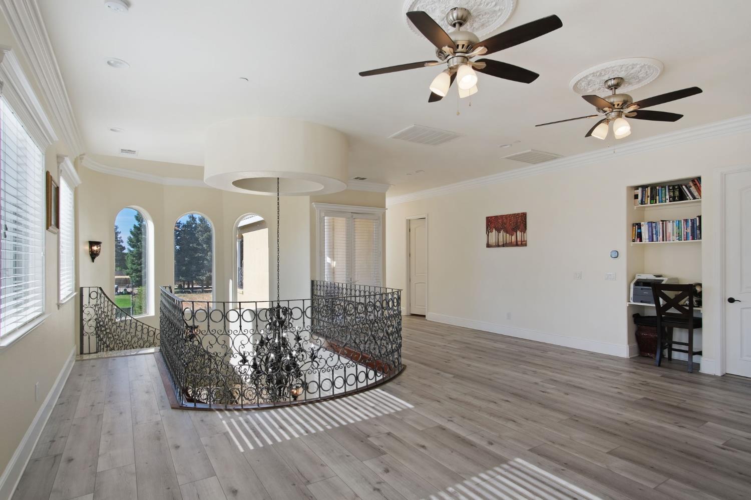 3205 Hillglen Avenue Modesto, CA 95355 - Photo 24 of 45 a view of a livingroom with furniture wooden floor a ceiling fan and windows