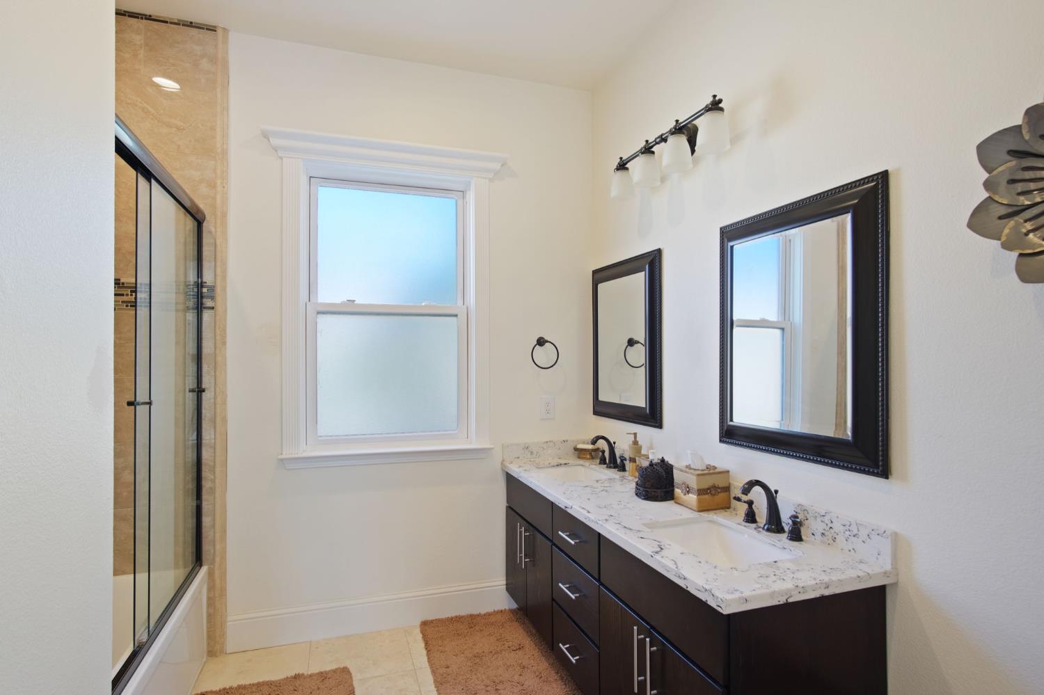 3205 Hillglen Avenue Modesto, CA 95355 - Photo 32 of 45 a bathroom with a sink vanity and mirror