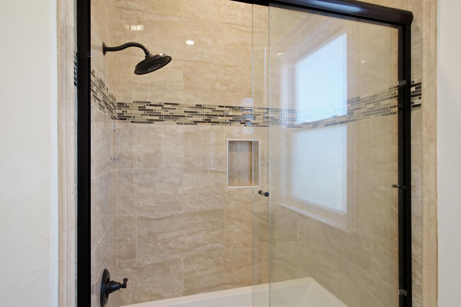 3205 Hillglen Avenue Modesto, CA 95355 - Photo 33 of 45 a bathroom with a glass shower door