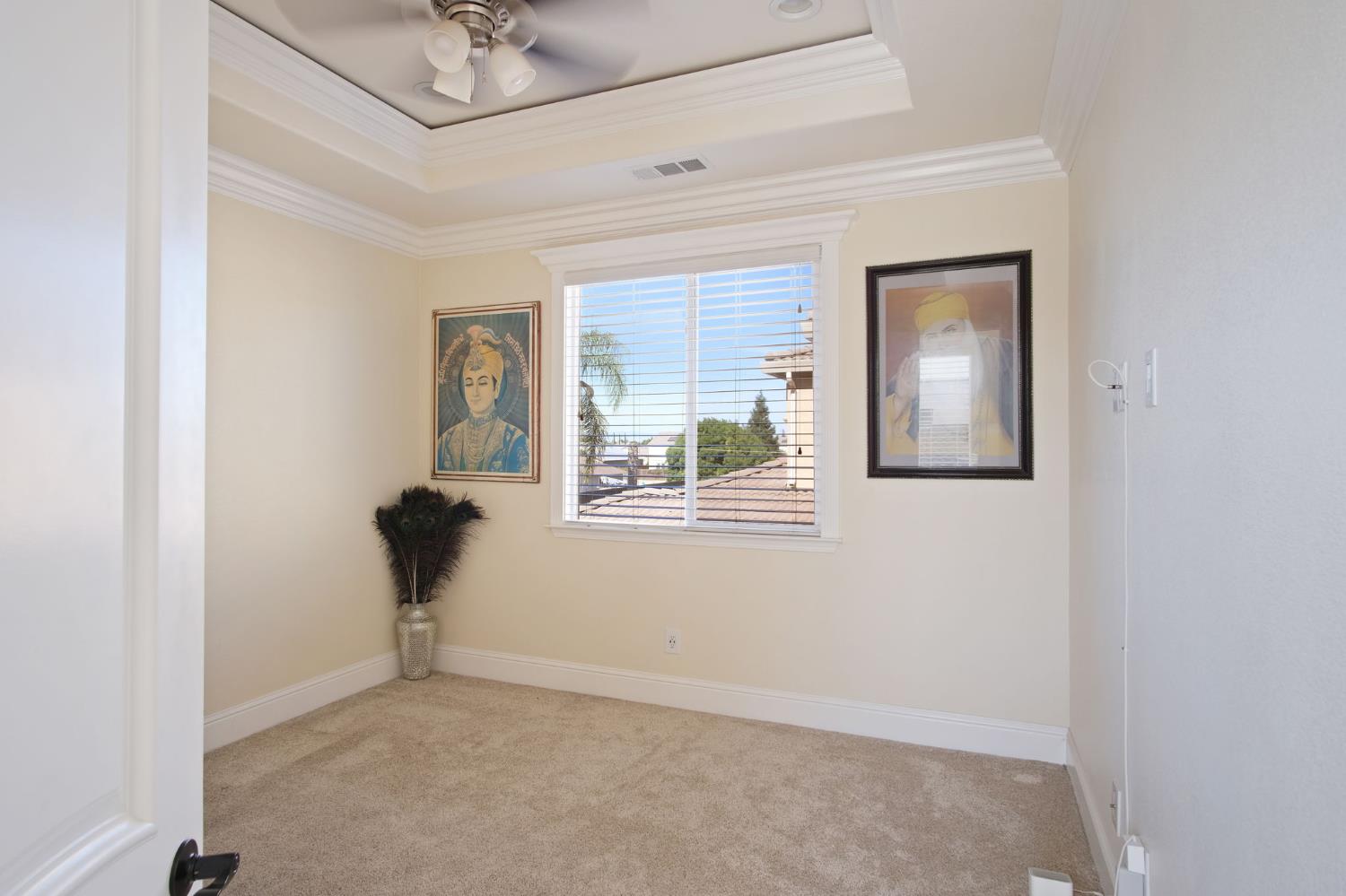 3205 Hillglen Avenue Modesto, CA 95355 - Photo 34 of 45 an empty room with windows and ceiling fan