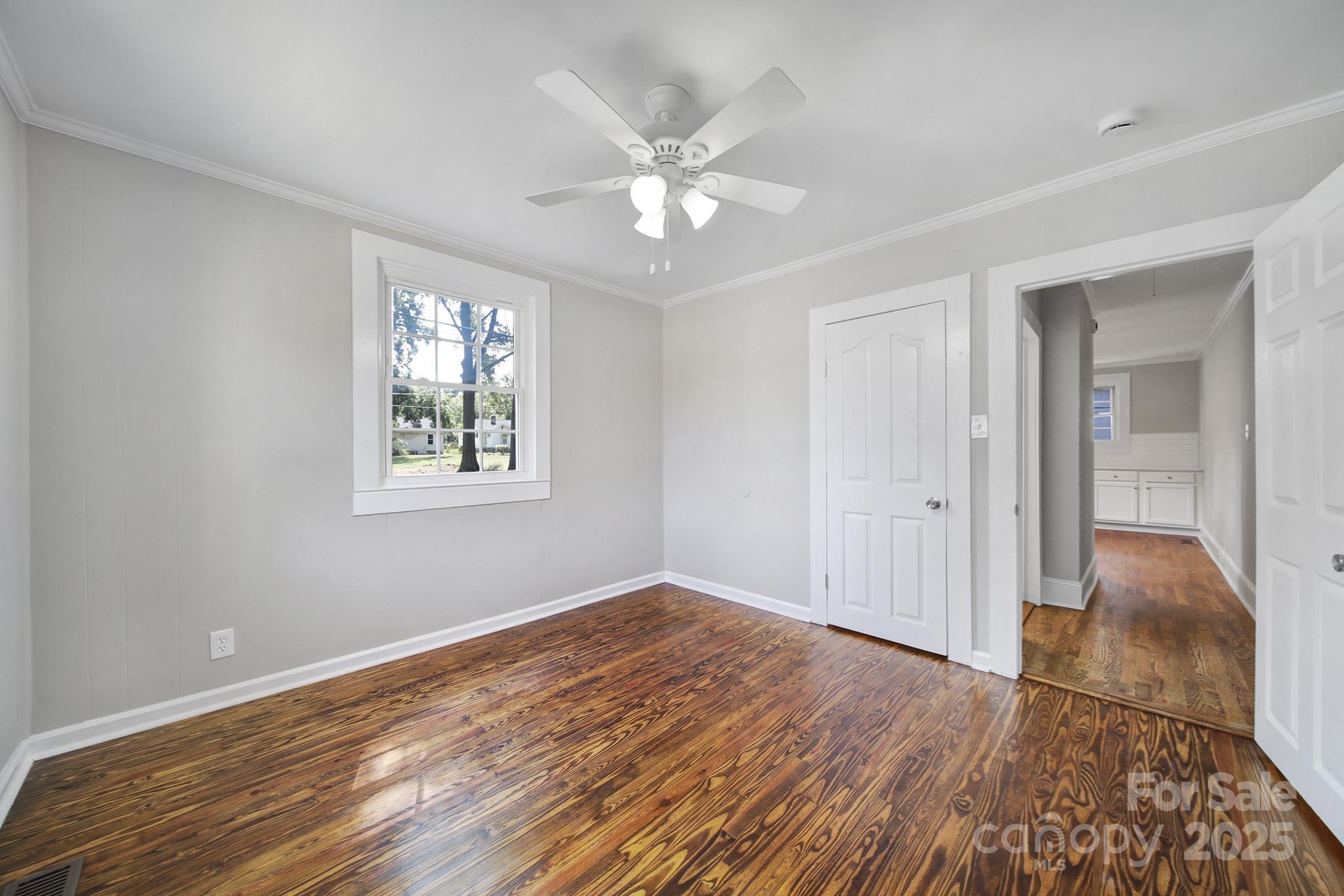 744 Cauthen Street Rock Hill, SC 29730 - Photo 16 of 28 a view of an empty room with wooden floor and a ceiling fan