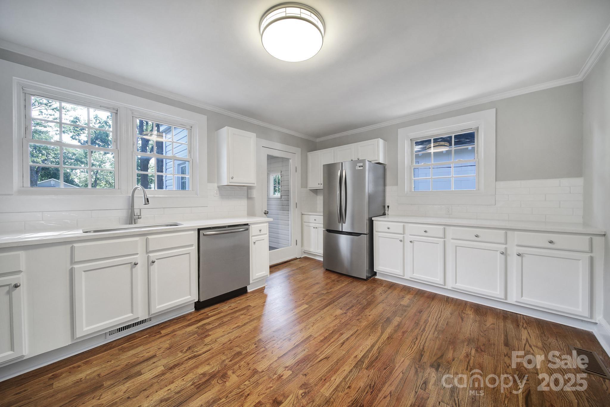744 Cauthen Street Rock Hill, SC 29730 - Photo 17 of 28 a kitchen with granite countertop white cabinets and white appliances