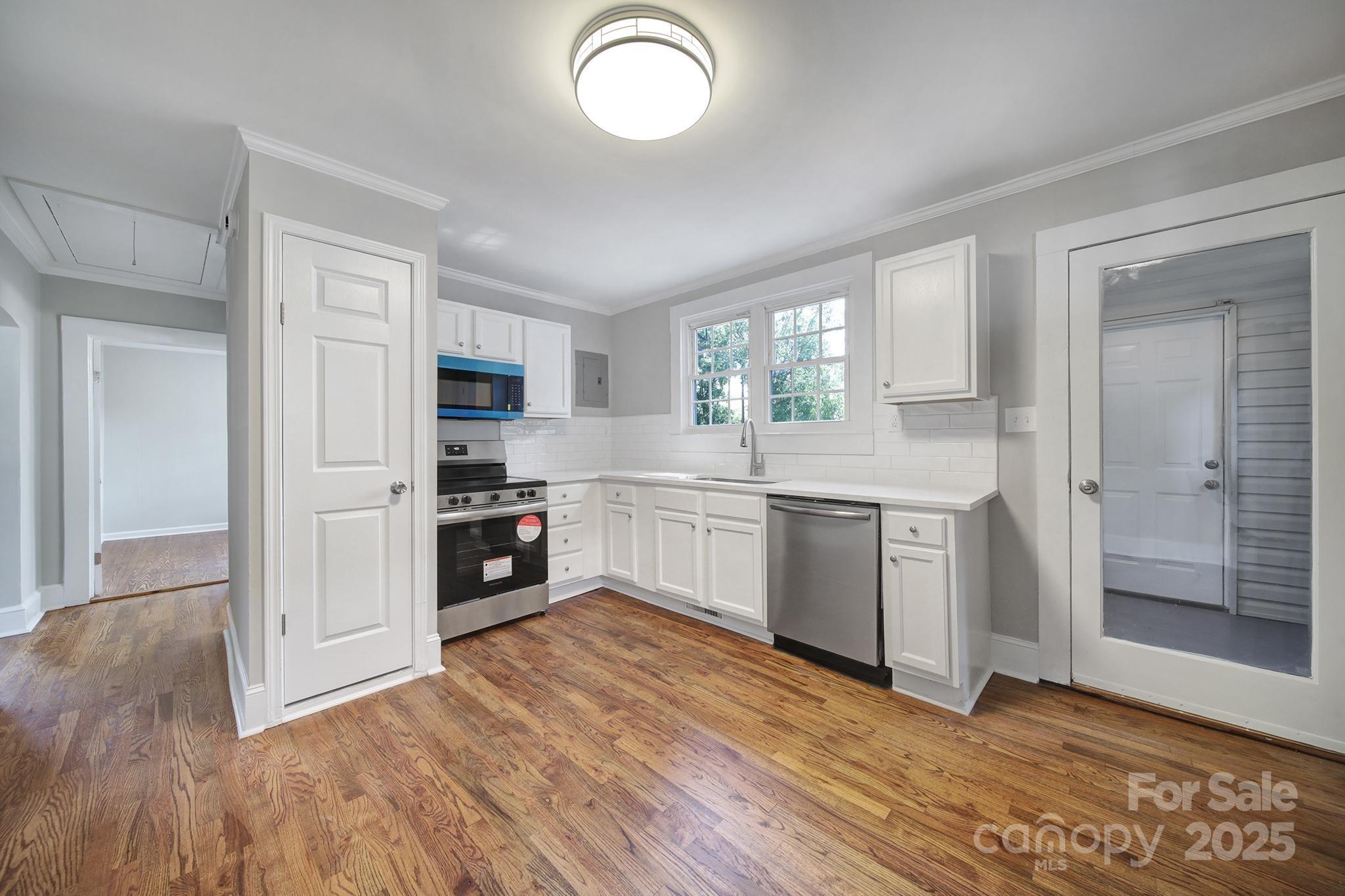 744 Cauthen Street Rock Hill, SC 29730 - Photo 18 of 28 a kitchen with a refrigerator and a stove top oven