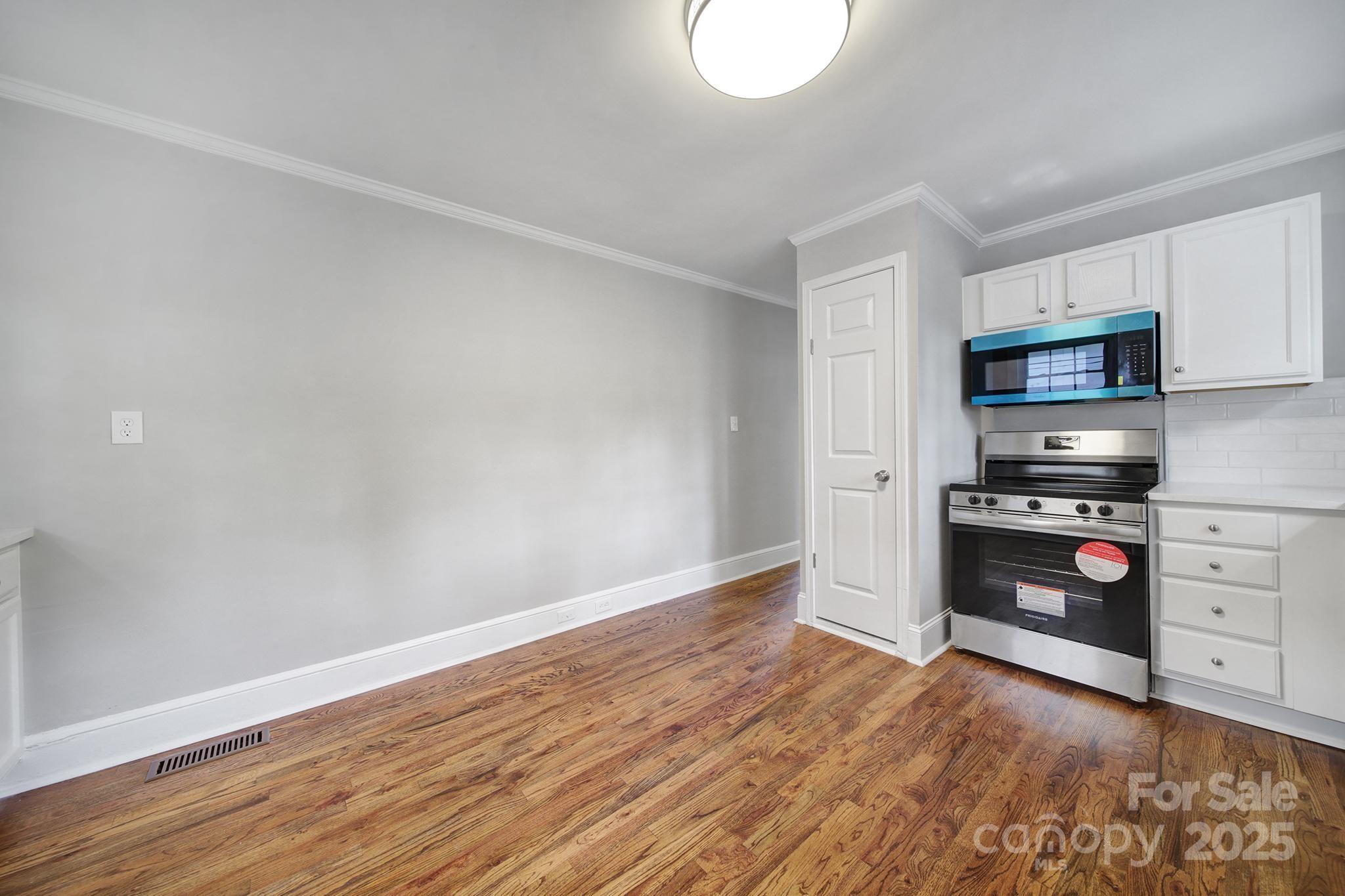 744 Cauthen Street Rock Hill, SC 29730 - Photo 19 of 28 a kitchen with granite countertop white cabinets and stainless steel appliances