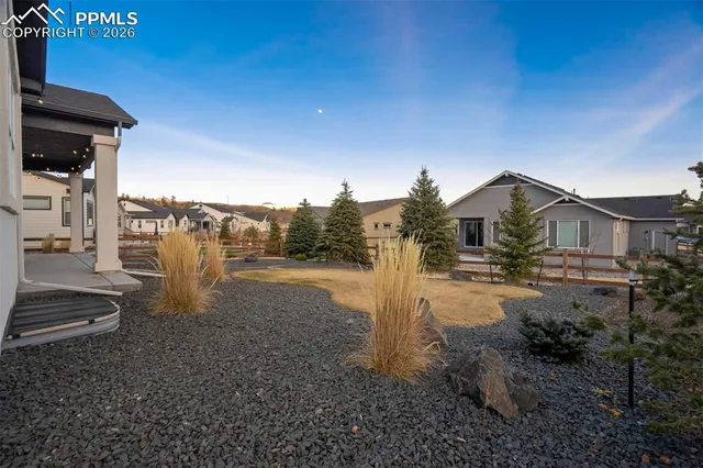 a view of a house with backyard and sitting area