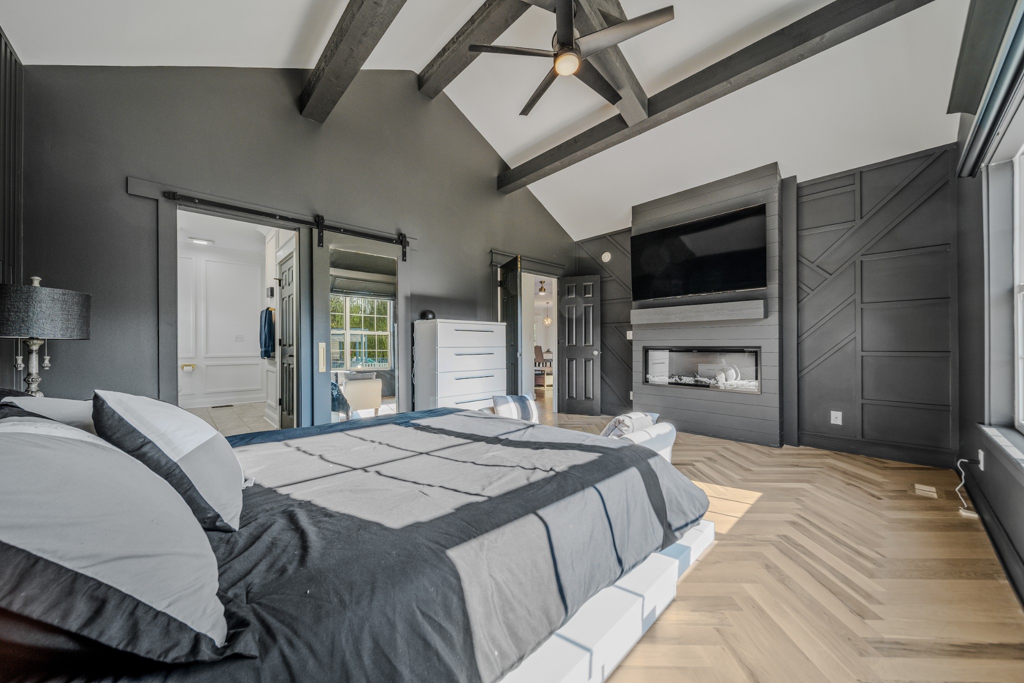 832 Blakemore Road Dickson, TN 37055 - Photo 25 of 42 a spacious bedroom with a bed a chandelier and a flat screen tv