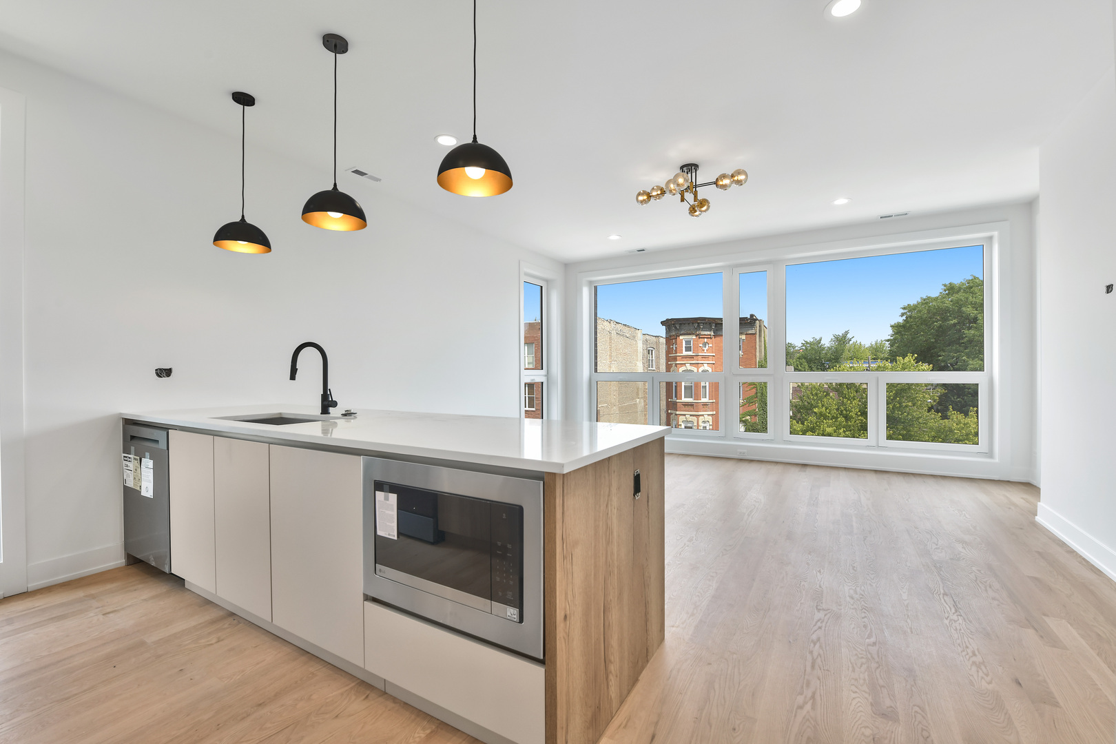 1244 North Kedzie Avenue, Unit 4 Chicago, IL 60651 - Photo 6 of 26 a view of a kitchen sink a stove and wooden floor