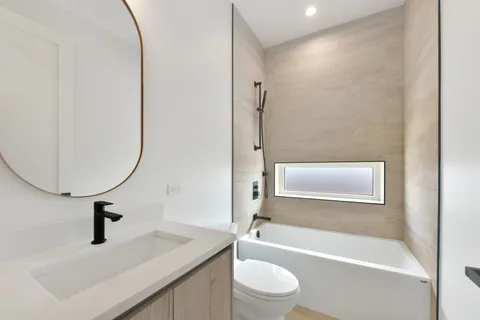 a bathroom with a sink a toilet and a bathtub