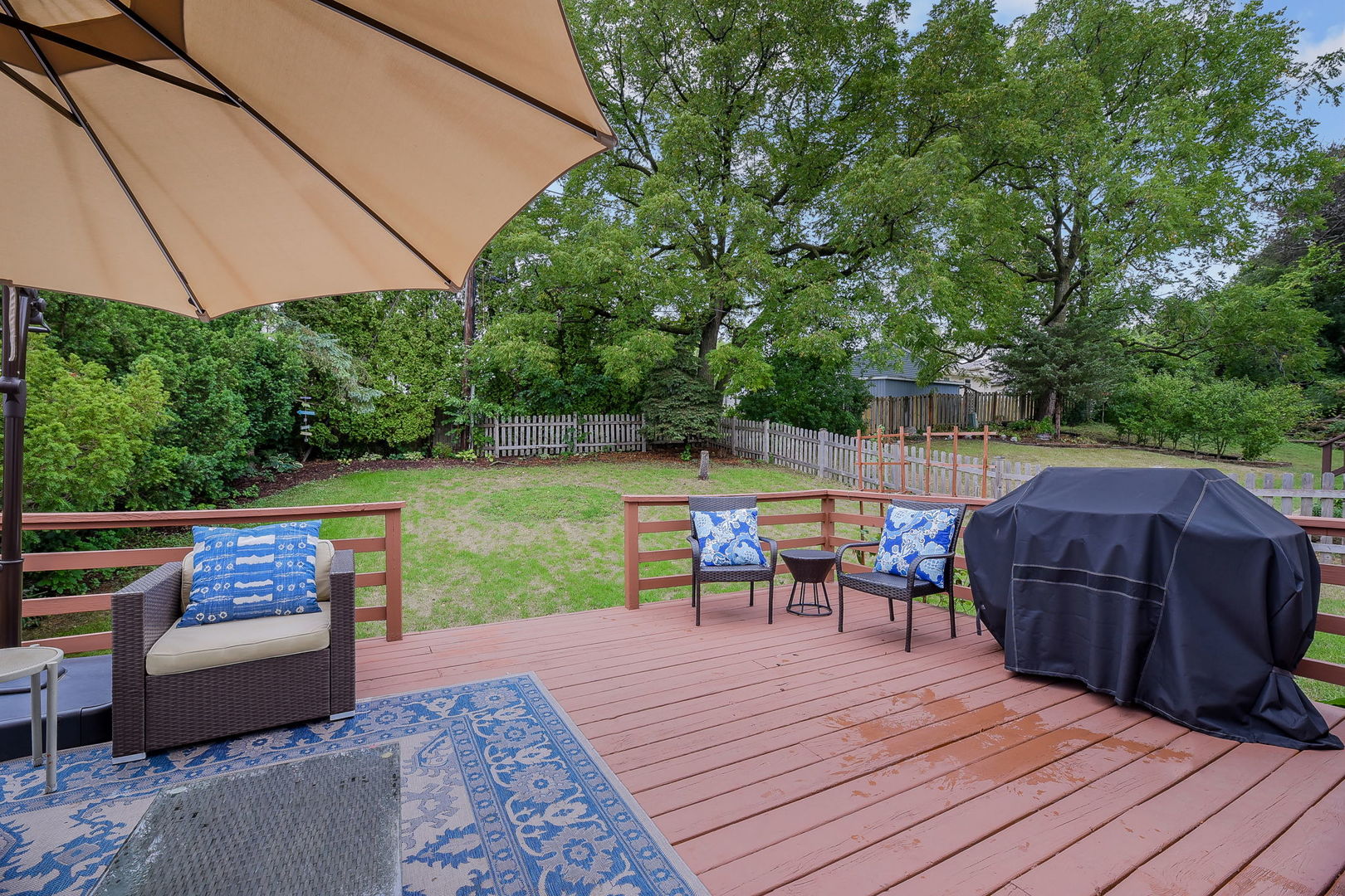 N020 Pleasant Hill Road Wheaton, IL 60187 - Photo 15 of 16 a view of a roof deck with table and chairs under an umbrella