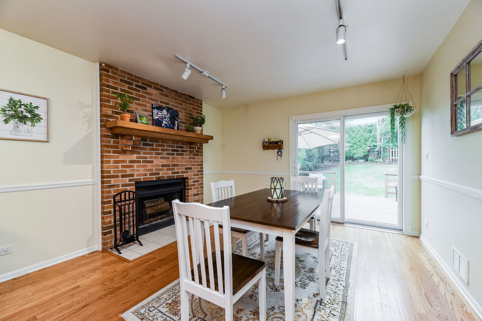 N020 Pleasant Hill Road Wheaton, IL 60187 - Photo 5 of 16 a dining room with furniture a fireplace and wooden floor