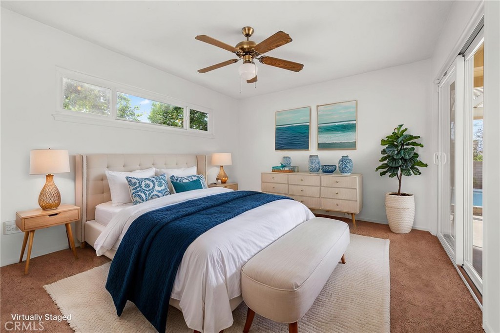 5593 Malvern Way Riverside, CA 92506 - Photo 14 of 54 a spacious bedroom that has a bed and a table in it