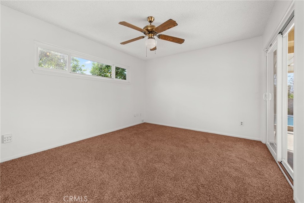 5593 Malvern Way Riverside, CA 92506 - Photo 16 of 54 an empty room with ceiling fan and window