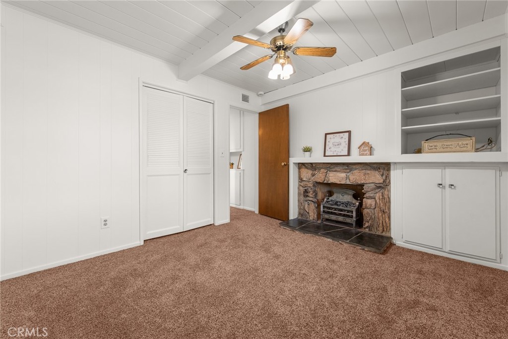 5593 Malvern Way Riverside, CA 92506 - Photo 19 of 54 an empty room with windows and fireplace