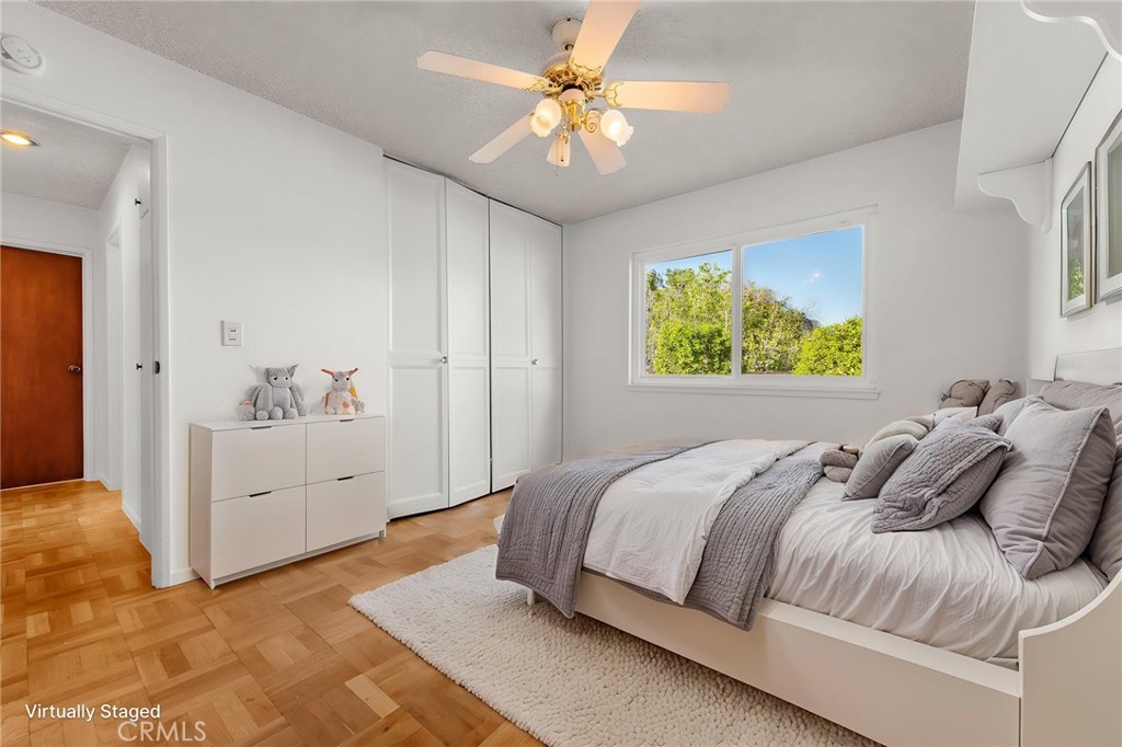 5593 Malvern Way Riverside, CA 92506 - Photo 24 of 54 a bedroom with a bed and a chandelier