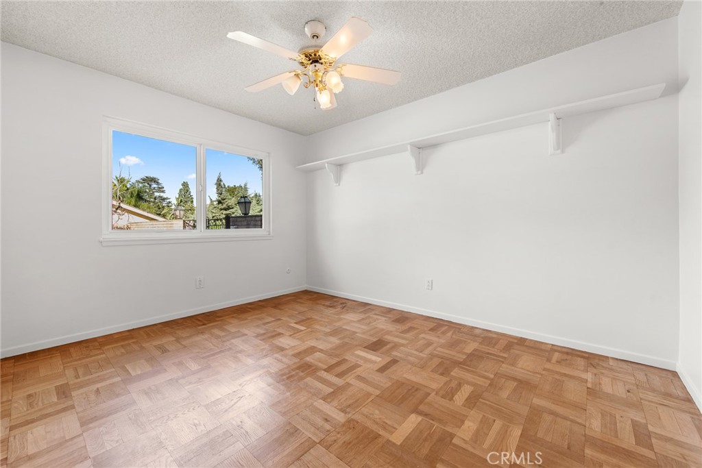 5593 Malvern Way Riverside, CA 92506 - Photo 26 of 54 an empty room with a window and a ceiling fan