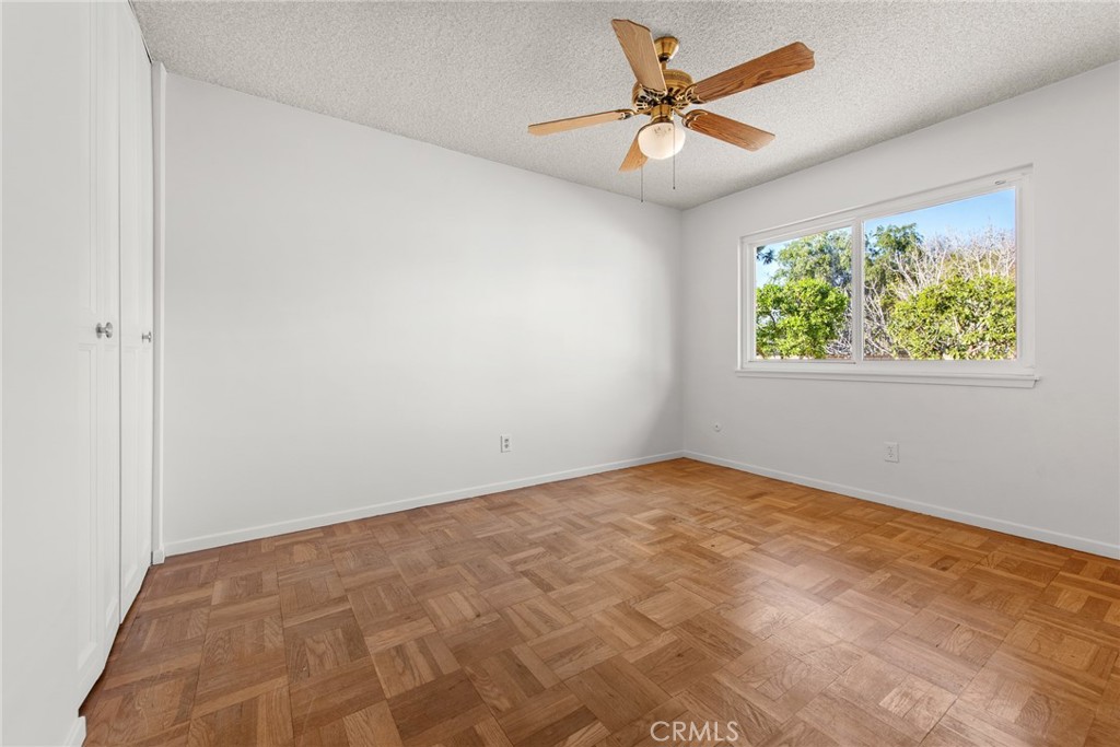 5593 Malvern Way Riverside, CA 92506 - Photo 27 of 54 an empty room with a window and a fan