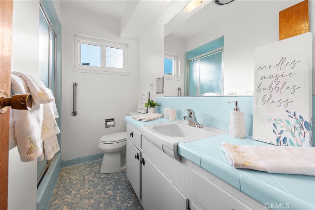 5593 Malvern Way Riverside, CA 92506 - Photo 28 of 54 a bathroom with a granite countertop sink and a mirror