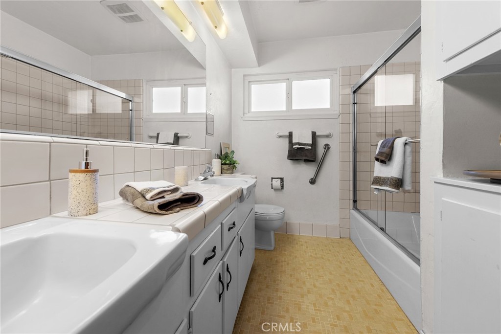 5593 Malvern Way Riverside, CA 92506 - Photo 29 of 54 a bathroom with a sink a toilet and shower