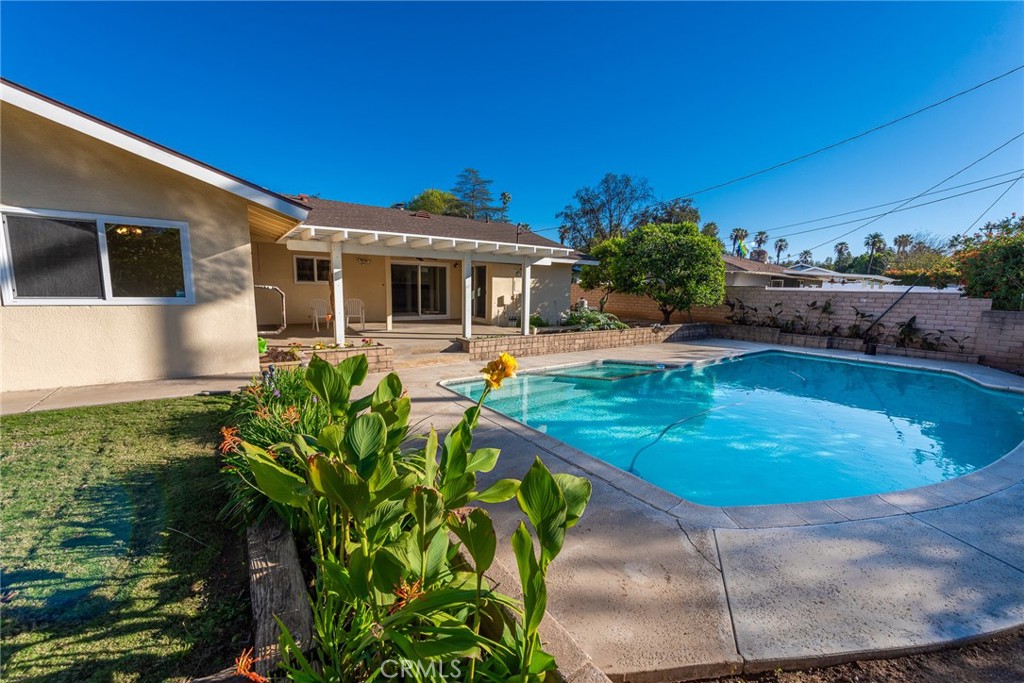 5593 Malvern Way Riverside, CA 92506 - Photo 39 of 54 a swimming pool with outdoor seating and yard