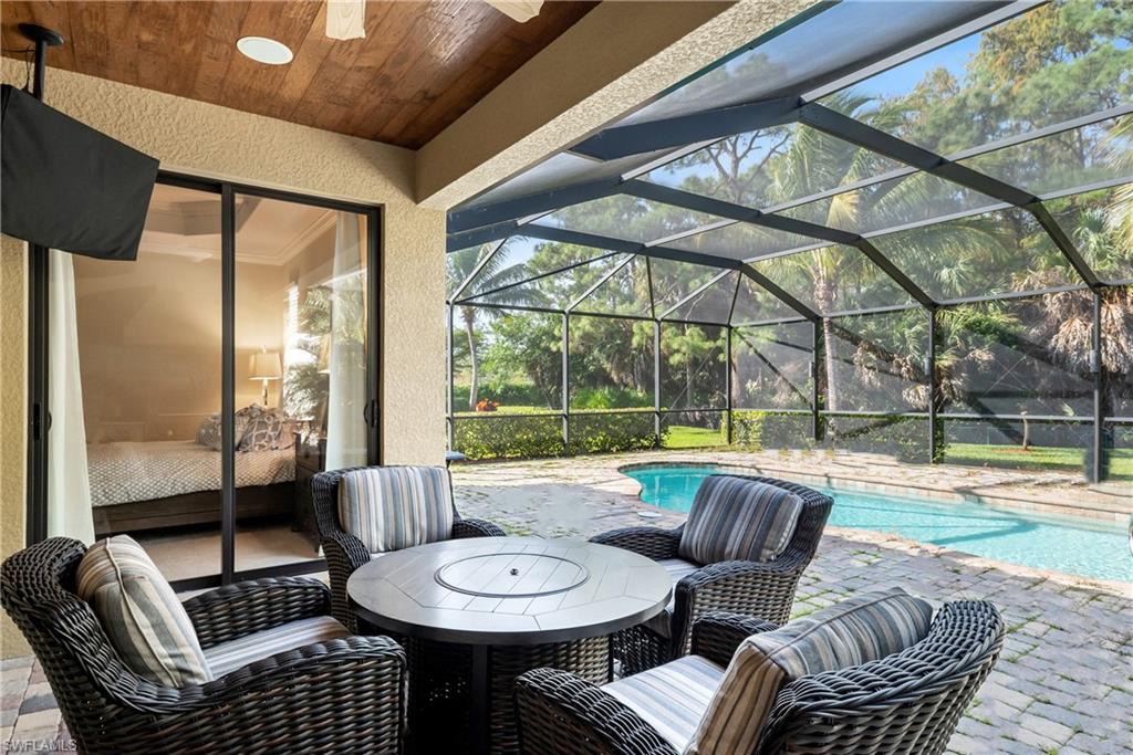 9487 Piacere Way Naples, FL 34113 - Photo 6 of 35 a living room with furniture and a floor to ceiling window