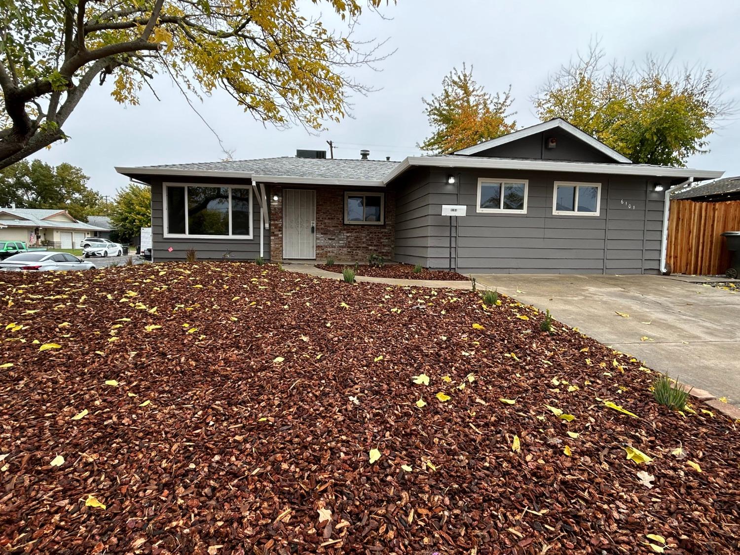a front view of a house with a garden