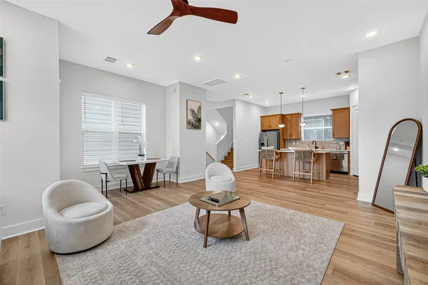a living room with furniture and a wooden floor