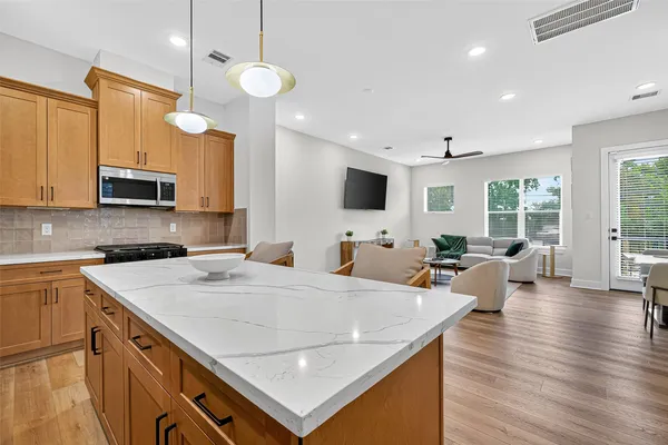 a view of kitchen with sink microwave and stove