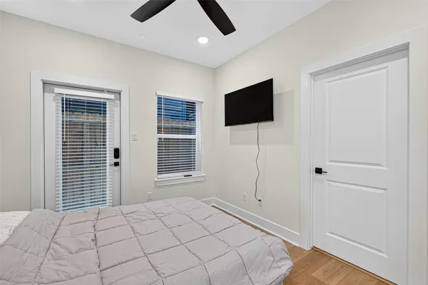 a bedroom with a bed and a flat screen tv