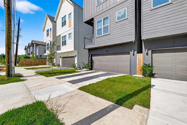 a view of a house with a yard and pathway